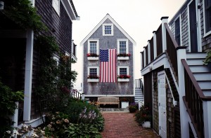 A home with an american flag hanging on the side of it